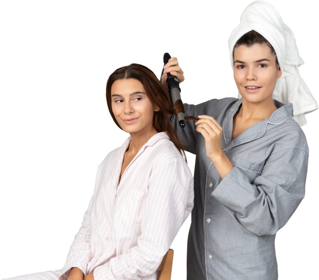 two women styling their hair with a hair dryer